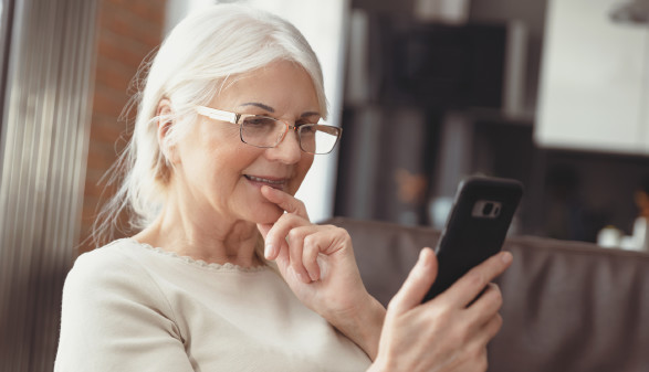 &Auml;ltere Dame mit Handy in der Hand